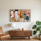 Colorful abstract faces art on a TV above a walnut credenza with a brass lamp and a monstera plant