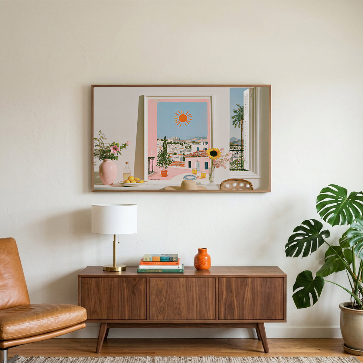 Athens summer still life art on a TV above a walnut credenza with a brass lamp and a monstera plant
