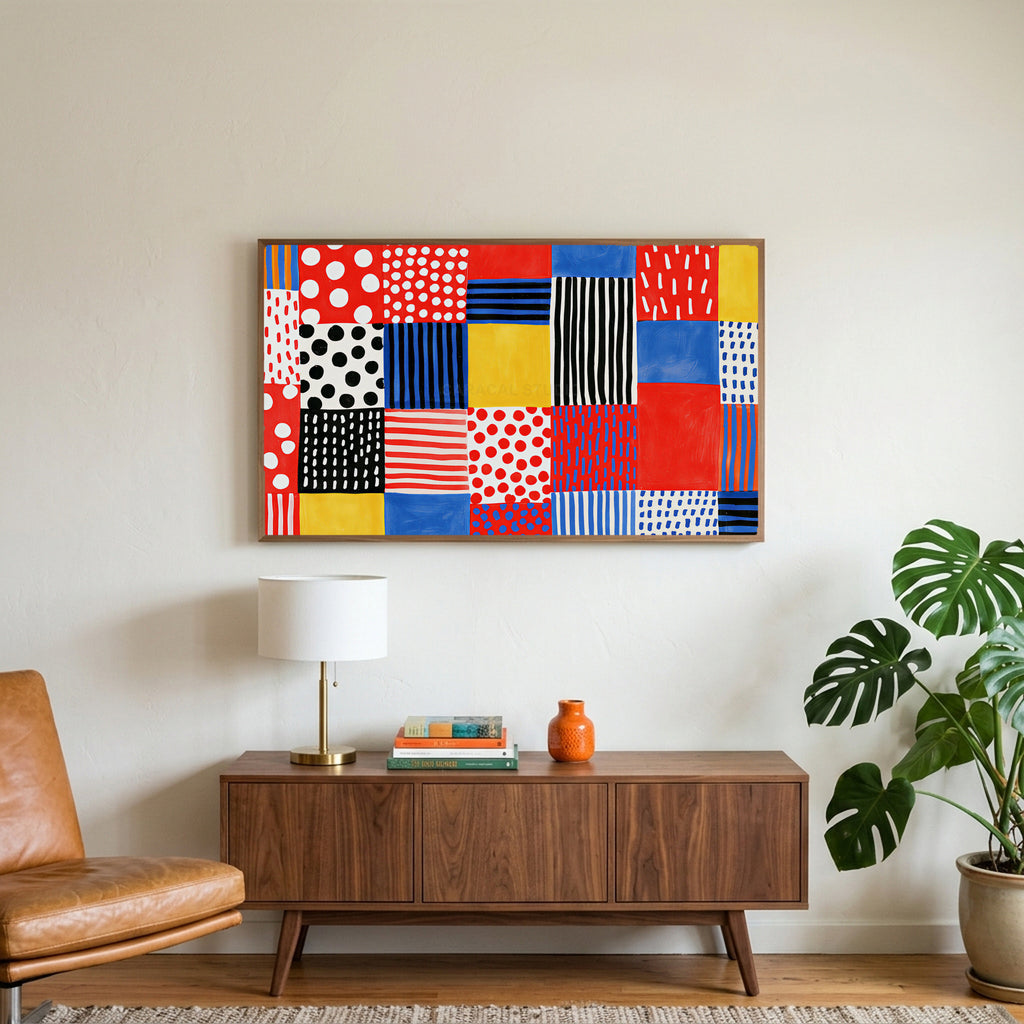Polka dot patchwork art on a TV above a walnut credenza with a brass lamp and a monstera plant
