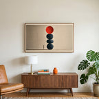 Stacked stones art on a TV above a walnut credenza with a brass lamp and a monstera plant