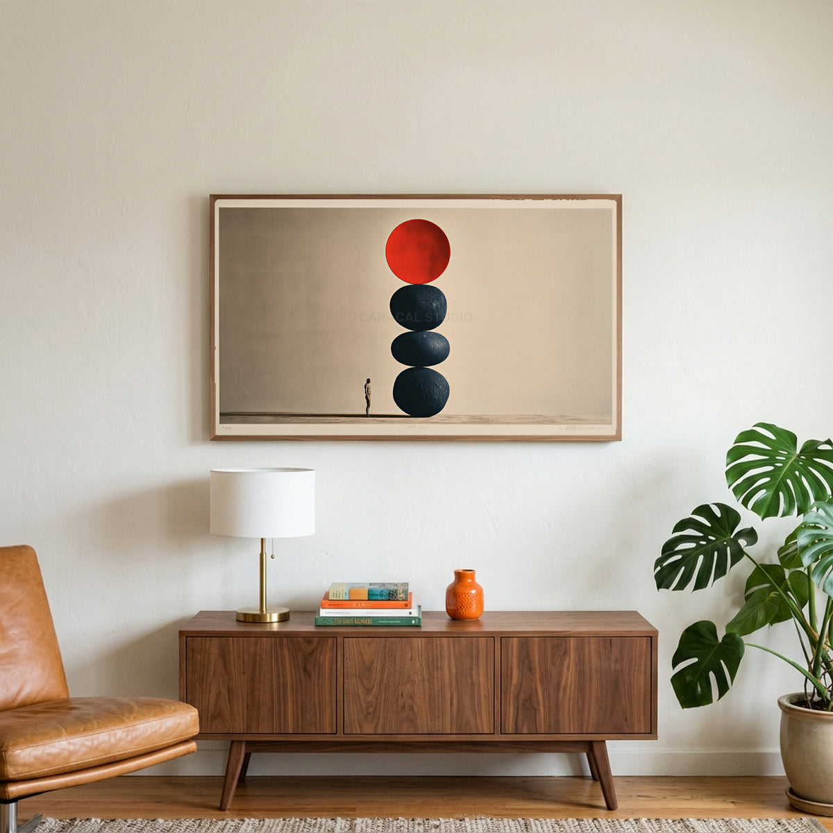 Stacked stones art on a TV above a walnut credenza with a brass lamp and a monstera plant