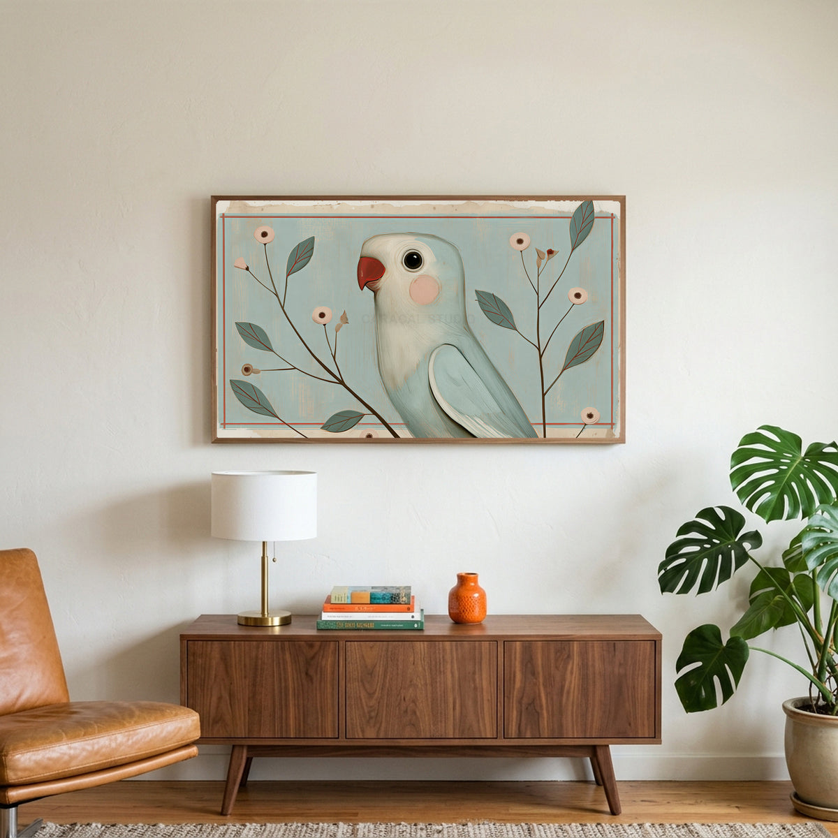 Vintage blue parrot art on a TV above a walnut credenza with a brass lamp and a monstera plant