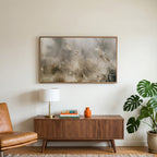 Misty meadow art on a TV above a walnut credenza with a brass lamp and a monstera plant