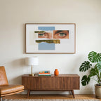 Eye collage art on a TV above a walnut credenza with a brass lamp and a monstera plant