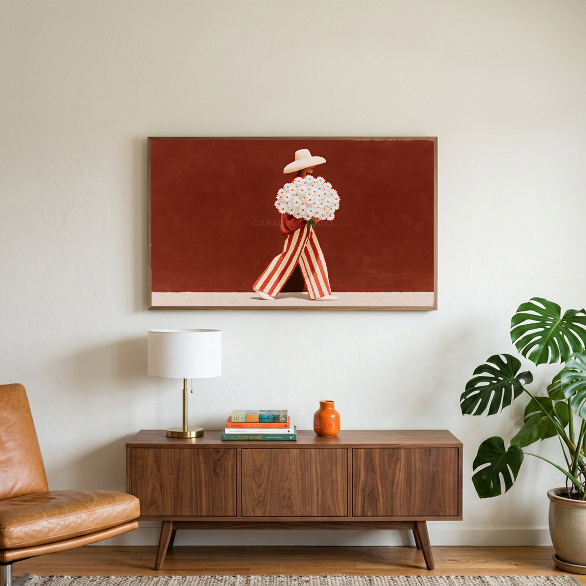 Figure with a daisy bouquet art on a TV above a walnut credenza with a brass lamp and a monstera plant