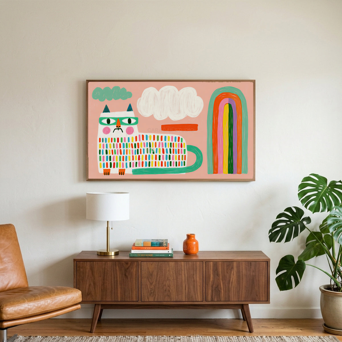 Rainbow cat art on a TV above a walnut credenza with a brass lamp and a monstera plant