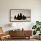 Snowy pine trees art on a TV above a walnut credenza with a brass lamp and a monstera plant