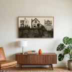 Three houses art on a TV above a walnut credenza with a brass lamp and a monstera plant