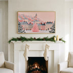 Pink Christmas tree in a snowy village as Frame TV art above a white fireplace with stockings