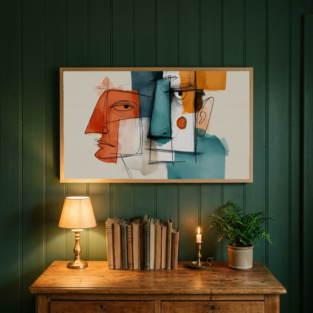 Cubist faces art on a forest green wall above a wooden dresser with a brass lamp