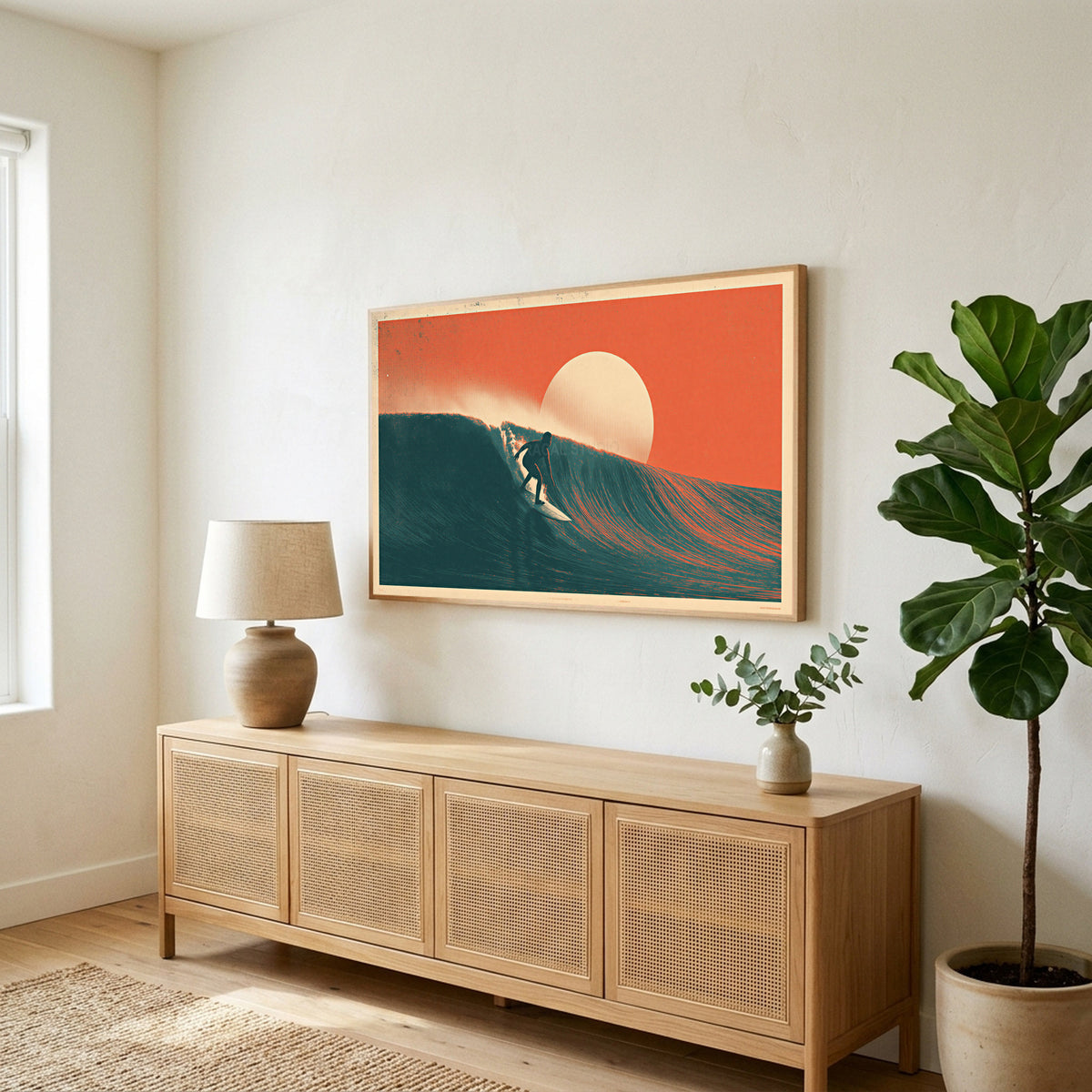 Side view of the Surfer on a wave TV art above a rattan sideboard next to a fiddle-leaf fig