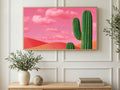 Saguaro Under Pink Sky art on a TV in a living room