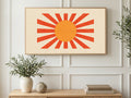 Orange Sunburst art on a TV in a living room