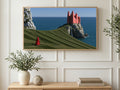 Pink Castle Sea Cliff art on a TV in a living room