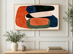 Rust and Navy Shapes art on a TV in a living room