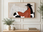 Cow Print Cowgirl art on a TV in a living room