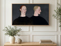 Redhead and Blonde Portrait art on a TV in a living room