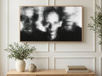 Blurred Photocopy Faces art on a TV in a living room