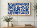 Blue Paper Cut Flowers art on a TV in a living room