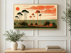 Orange Sun Tree Silhouettes art on a TV in a living room