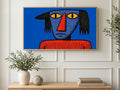 Glum Blue Face art on a TV in a living room