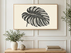 Halftone Monstera Leaf art on a TV in a living room