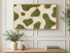Olive Cowhide Spots art on a TV in a living room